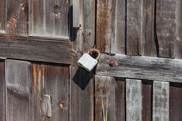 Locked old castle on the canopy of a wooden shed close-up