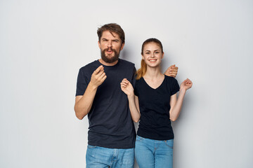 Fototapeta premium a young couple in black t-shirt sunglasses posing isolated background