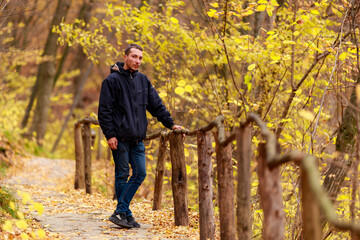A young man enjoys wildlife during the golden autumn. The concept of solitude with nature