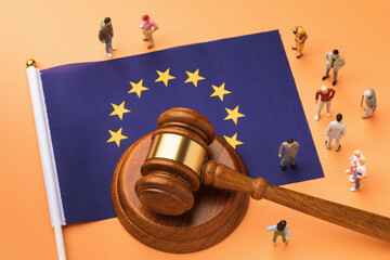 Judge gavel, flag and plastic toy men, the concept of litigation in European society - obrazy, fototapety, plakaty