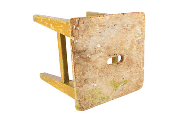 Old wooden stool with peeling ocher yellow paint. Loft style chair isolated on a white background.