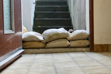 Protective measure against floods in basements. Barrier made of sandbags lies in the entrance area...