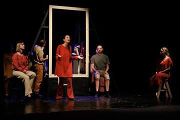 Actors and actresses perform a modern performance on the stage of the theater.