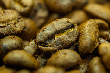 Brown grains of coffee beans. Close-up texture. Macro photo of food