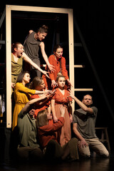 Actors and actresses perform a modern performance on the stage of the theater. - obrazy, fototapety, plakaty