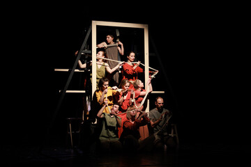 Actors and actresses perform a modern performance on the stage of the theater.