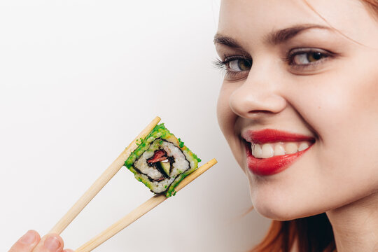 cheerful red-haired woman chopsticks sushi japanese cuisine
