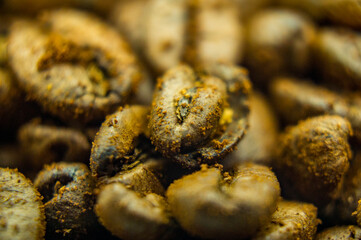 Brown grains of coffee beans. Close-up texture. Macro photo of food