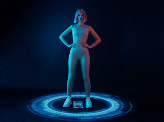 Woman in futuristic costume. Girl in glasses of virtual reality presses start button. Augmented reality game, future technology, AI concept. VR. Holographic interface to display data. Dark background.