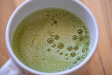Matcha tea over wood background