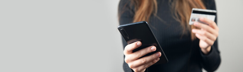 woman is holding credit card and smart phone