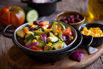 Avocado salad with other vegetables, tomatoes and corn. Healthy food