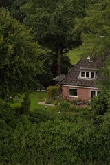 Rendsburg, Germany - 07 21 2020: Cosy house in the forest. German architecture. Beautiful house and the yard.