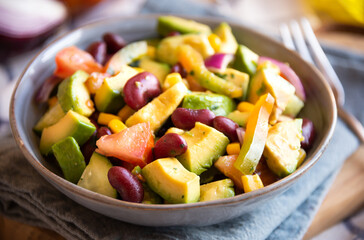 Avocado salad with other vegetables, tomatoes and corn. Healthy food