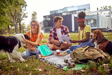  man  studying with female friends at college campus