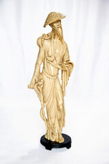 An old arty oriental statuette of a wise Chinese dignitary from 1900 isolated over white.