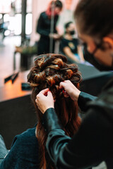 Unrecognizable woman getting her hair done at the hairdresser salon