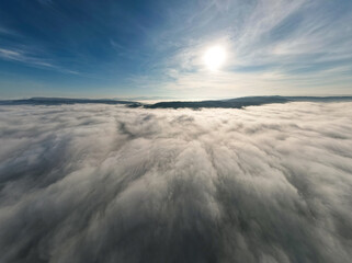 Obraz premium Clouds and sky over mountain from airplane window, Aerial view for nature background