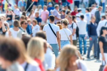 Crowd of people with men and women on busy city street