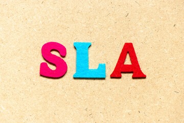 Color cloth alphabet letter in word SLA (Abbreviation of Service level agreement) on wood background