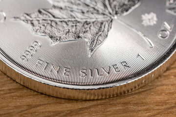 Edelmetall auf einem Holu-Hintergrund: Kanadische Anlagem&uuml;nze 1 Unze Feinsilber 9999 - Canada Maple Leaf FINE SILVER 9999 - Canadian Silver Maple Leaf Coin