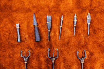 Arrowheads of various shapes and sizes. Archaeological samples of ancient weapons against the...