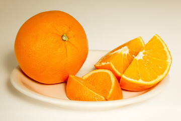 Orange on a plate with slices