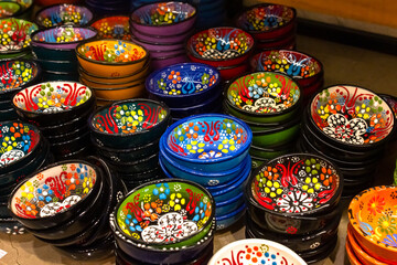 National patterns on ceramic dishes. Multicolored plates with traditional patterns are on the shelf