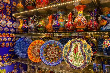 National patterns on ceramic dishes. Multicolored plates with traditional patterns are on the shelf