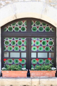 Colorful window in the medieval village of Perouges in France 