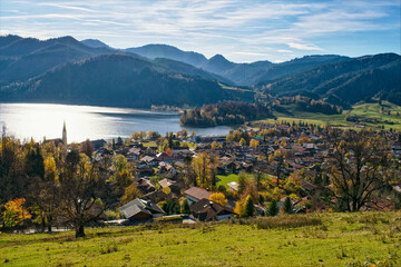 Panoramic view of Schliersee lake during Autumn with Alps as a background. Mountain lake Schliersee during Fall and a small city in german Alps, Bavaria, Germany
