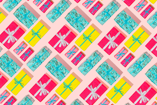 Inspirational pattern of Christmas gifts in various colors. Holidays composition on pink backgrounds.