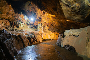 Uneven brown cave walls with lighting inside