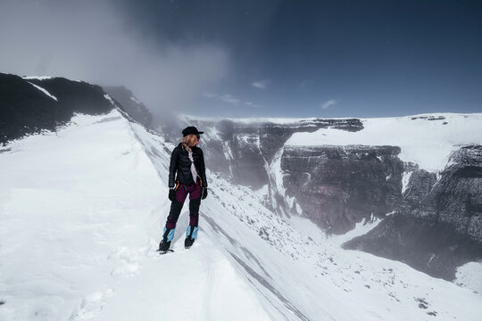 Traveler Woman on the snowy peak of crater active Tolbachik volcano, Kamchatka