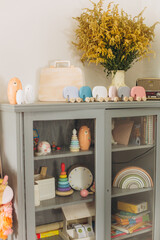 Obraz na płótnie Canvas Shelf with wooden colorful eco toys for children