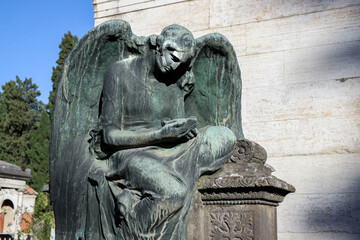 Naklejka premium Bronze statue of Angel inside the monumental cemetery of Verano in Rome.