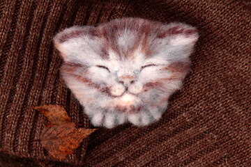 Sleeping cat brooch with knitted background. Wool kitten brooch. Handmade animal jewelry.