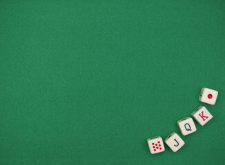 The dice  on the green cloth of the gambling table. Dice game. Yahtzee poker.