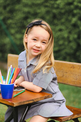 Back to school portrait image of little girl wearing uniform