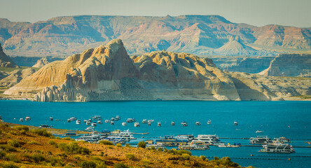 Beautiful rock mountains and blue river with boats. Glen Canyon National Recreation Area