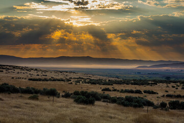Amazing sunset with orange sky and clouds over the hills. Idaho, USA