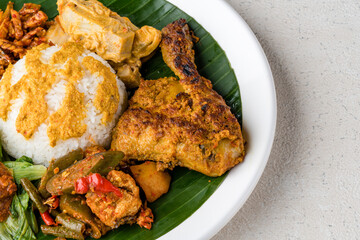 Nasi Padang with  chicken rendang  is an Indonesian food from West Sumatra in Indonesia.
Nasi Padang Chicken Roast as favorites food for Indonesian people.