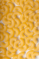 Neat uncooked chifferi pasta on a white background. Pasta background