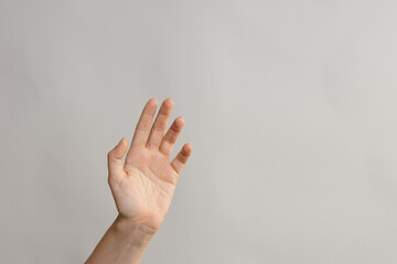 Hand gestures, to wave Hello. Greeting someone. light grey background