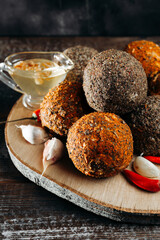 Craft colorful balls of belper knole cheese - handmade crafted hard cheese on a wooden board at the cheese factory