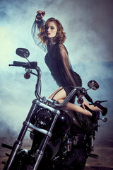 Obraz na płótnie Canvas elegant girl on a motorcycle