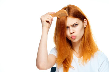 pretty red haired woman hair care posing light background
