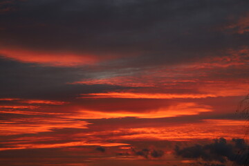 Fototapeta na wymiar dramatic clouds in crimson color during sunrise