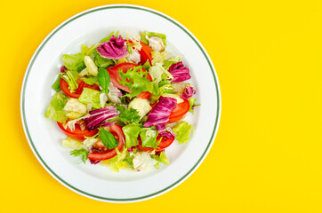 Light dietary vegetarian salad in plate on bright background. Healthy lifestyle concept