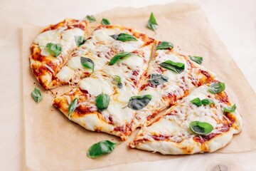 oval pizza on a plywood background, top view, hand made margarita